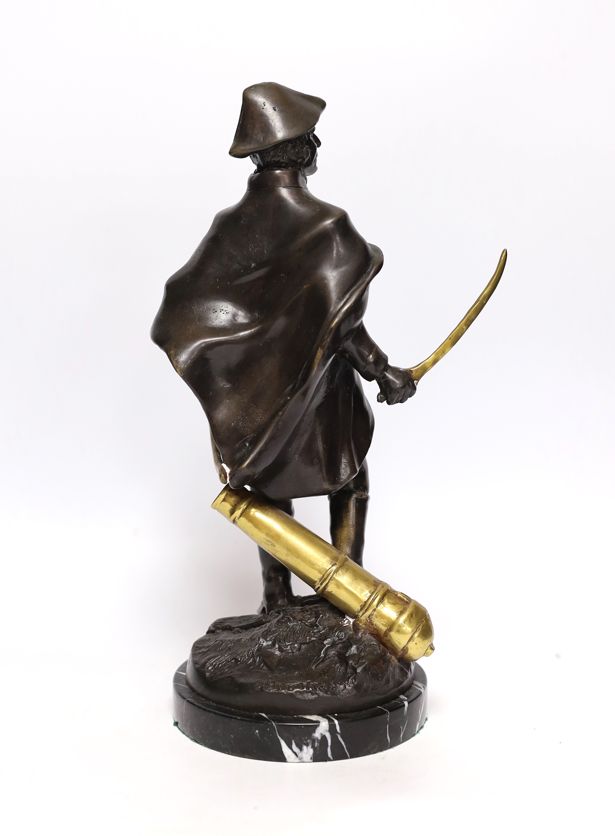 A bronze figure of Wellington with brass sword blade and cannon, signed ‘Boucher’, mounted on a marble base, 34cm